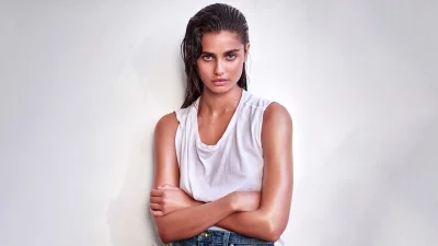 Captivating Young Woman with Wet Hair and Intense Gaze in Casual Attire image