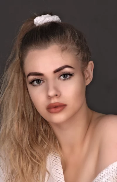 Blonde Haired Woman Portrait with Serious Look and White Scrunchee image