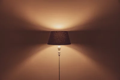 Warm Floor Lamp Illumination on Wall Creating Cozy Ambiance image