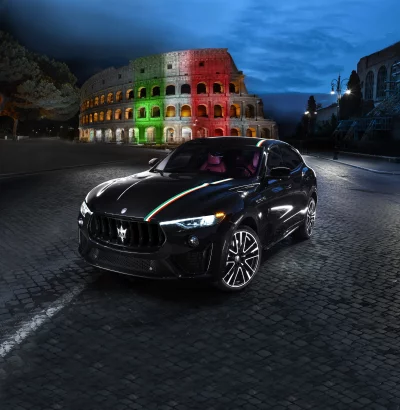 Luxurious Black Maserati Levante SUV with Italian Flag Lights at Historic Colosseum Night image
