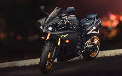 Sleek Black Yamaha R1 Sport Motorcycle with Gold Wheels at Night image