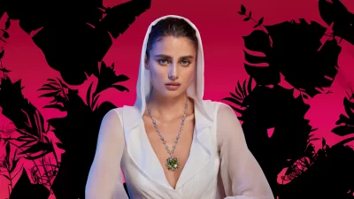 Striking Portrait of Woman in White Hood with Elaborate Green Gemstone Necklace image