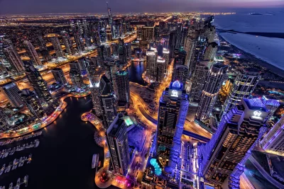 Vibrant Dubai Marina Night Skyline: Illuminated Skyscrapers, Waterway & City Lights image