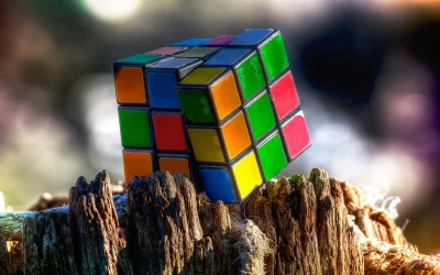 Vibrant Rubik's Cube Puzzle Resting on Rustic Wood in Sunlight image