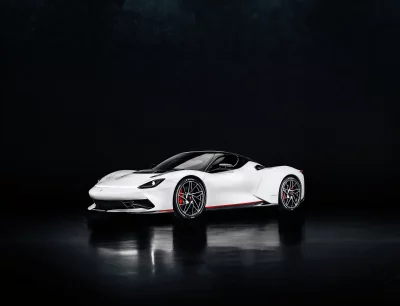 Sleek White Electric Hypercar on Dark Reflective Studio Background image