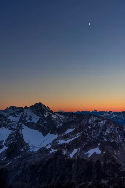 Crescent Above Glacier Peaks in Evening Alpine Glow image