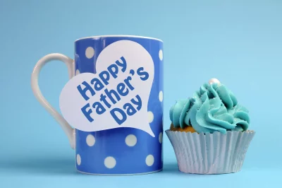 Thoughtful Happy Father's Day Mug with Blue Frosted Cupcake on Pastel Background image