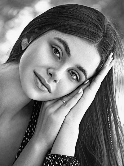 Captivating Black and White Portrait of Young Woman with Long Dark Hair and Clasped Hands image