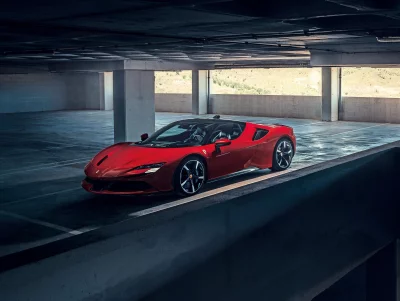 Stunning Red Ferrari Convertible Sports Car in Modern Concrete Parking Garage image