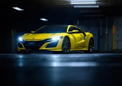 Sleek Yellow NSX Supercar Headlights Glaring in Dark Underground Parking Garage image