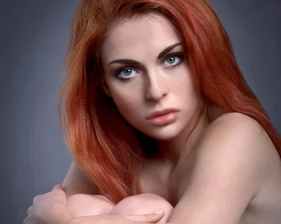 Captivating Young Woman with Red Hair and Intense Green Eyes Portrait image