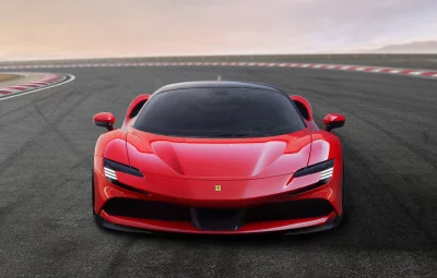 Performance Red Ferrari SF90 Stradale on Asphalt Racetrack at Dawn image
