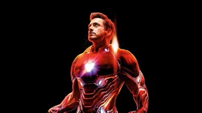 Robert Downey Jr. as Iron Man in iconic armored suit looking up with glowing elements image