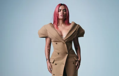 Stylish Woman with Pink Hair and Oversized Camel Coat Posing Confidently image