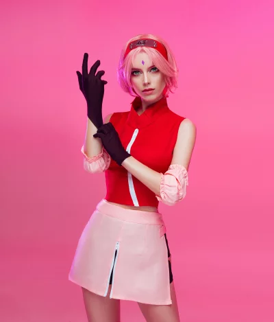 Vibrant Sakura Haruno Cosplay with Pink Hair and Ninja Attire Against a Bright Background image