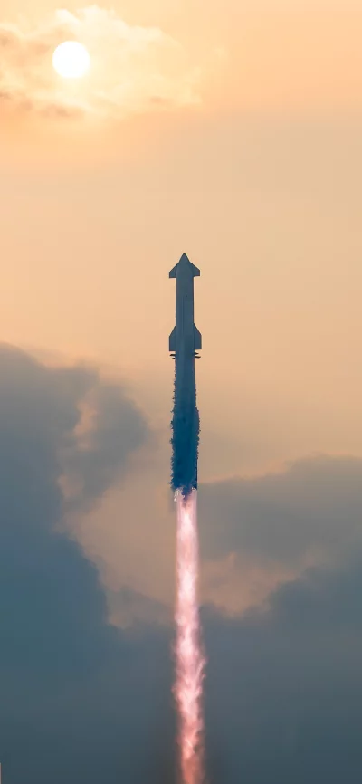 Rocket Launch Against a Sunset Sky with Plumes of Smoke