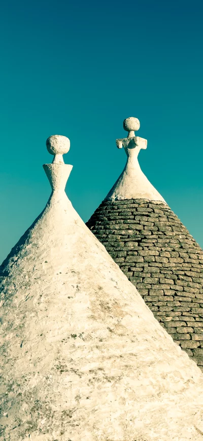 Iconic Trulli Dwellings with Distinctive White and Stone Conical Roofs image