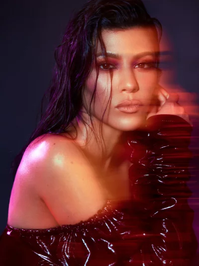 Glamorous Woman in Wet-Look Hair and Patent Leather Top with Neon Lights image