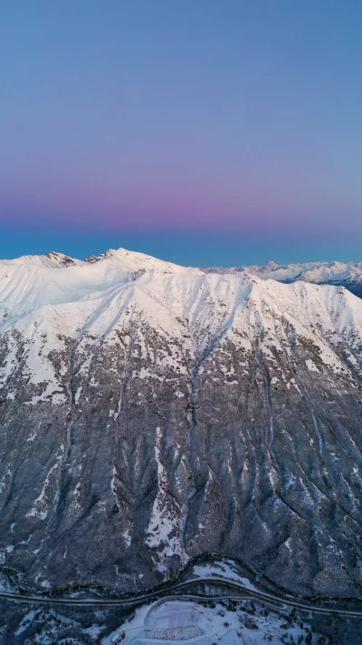 Snow-Capped Mountains Under a Pink and Blue Twilight Sky