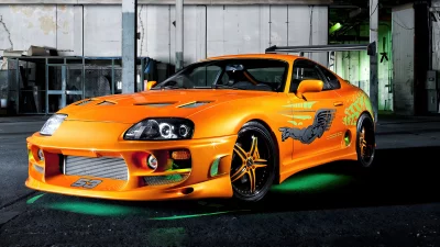 Vibrant Orange Tuned JDM Sports Car with Green Underglow in a Dark Garage image