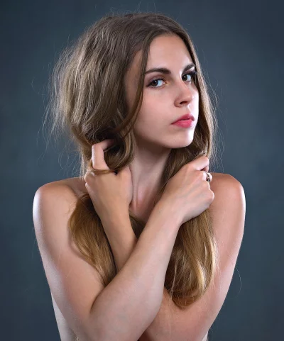 Beautiful Young Woman with Natural Wavy Hair and Modest Pose image
