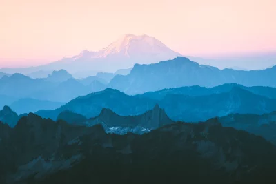 Cinematic Layered Mountains at Sunset: Hazy Peaks Under Pink and Blue Sky Wallpaper image