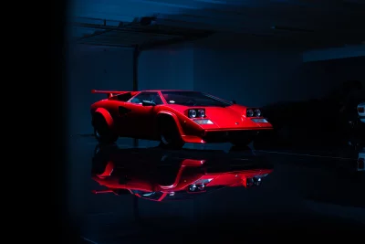 Iconic Red Lamborghini Countach Supercar Reflecting in a Dimly Lit Luxury Garage image
