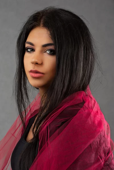 Confident Woman Posing with Long Dark Hair and Vibrant Pink Scarf image