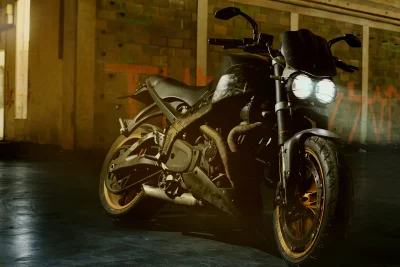 Black Performance Motorcycle with Golden Rims in Gritty Industrial Garage image