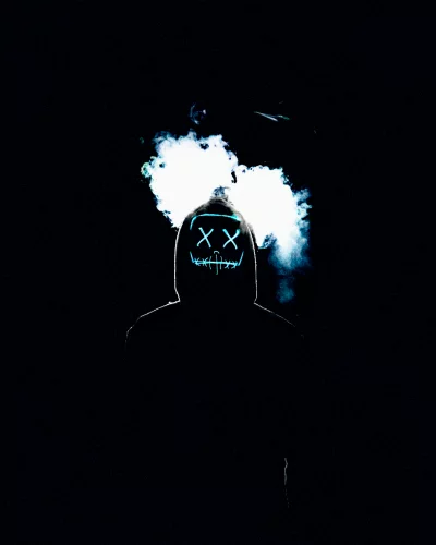 Anonymous Person in Dark Hoodie with Glowing Mask and Smoke Effect image