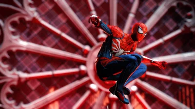 Dynamic Spider-Man in Iconic Red and Blue Suit Against Vibrant Red Geometric Background image
