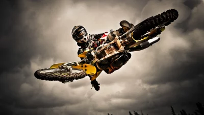 Dynamic Motocross Rider Performing Gravity-Defying Aerial Stunt on Dirt Bike image