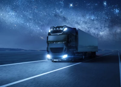 Modern Semi-Truck Speeding Under Dazzling Starry Night Sky and Milky Way image