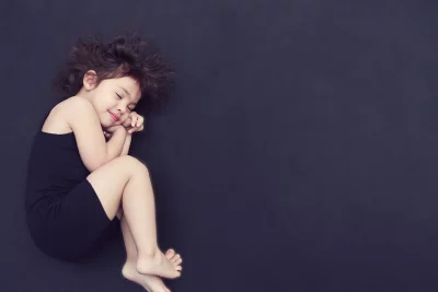 Peaceful Young Child Sleeping Serene on Dark Background image