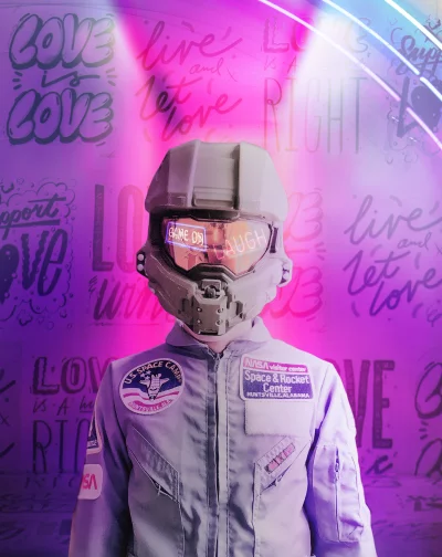 Futuristic Gamer in Neon Helmet and Space Suit with Inspiring Graffiti Background image