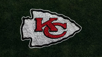 Kansas City Chiefs Football Team Logo on Green Grass Field Texture image