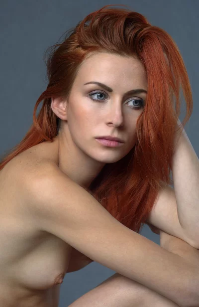 Pensive Redhead Woman with Blue Eyes, Freckles, and Natural Beauty Portrait image