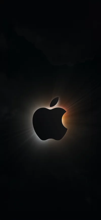 Iconic Apple Logo Illuminated by Radiant Light on Dark Background image