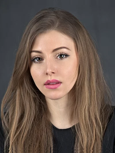 Studio Portrait of Young Woman with Long Wavy Hair and Green Eyes image
