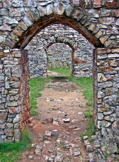 Series of Ancient Stone Archways Leading Through Historic Castle Ruins image