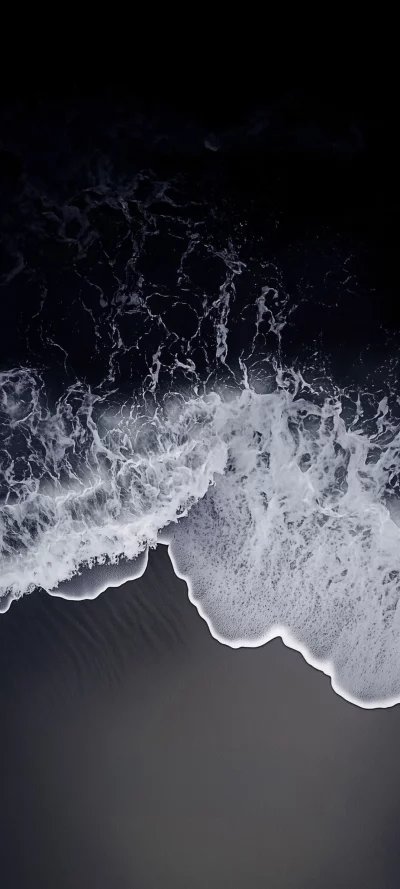 Dramatic Dark Ocean Waves with Foamy White Crests on a Mysterious Black Sand Beach image
