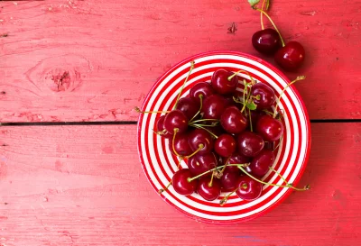 Fresh Red Cherries in Striped Bowl on Rustic Wooden Table image