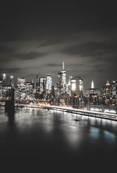 Spectacular Night View of New York City Skyline and Brooklyn Bridge Over East River image