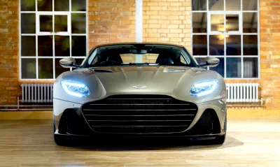 Sleek Aston Martin Sports Car with Illuminated LED Headlights in Modern Setting image