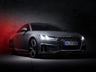 Sleek Grey Audi TT RS Sportscar with Dramatic Red Lighting in Dark Garage image