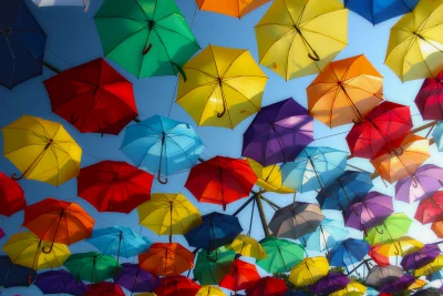 Vibrant Umbrella Sky Installation: Colorful Overhead Canopy Against Blue Sky image