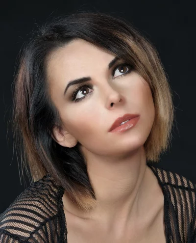 Captivating Woman with Bob Haircut and Expressive Gaze Looking Upwards image