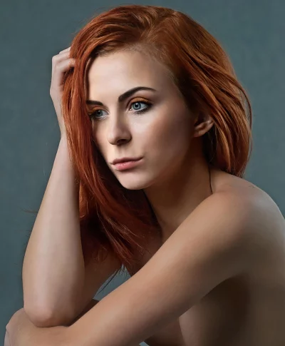 Pensive Young Woman with Vibrant Red Hair and Captivating Blue Eyes image