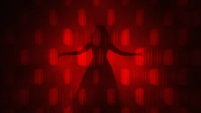 Dramatic Silhouette of Horned Figure in Red Light Patterns image
