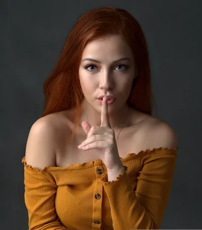 Redhead Woman Making Hush Gesture with Direct Eye Contact image